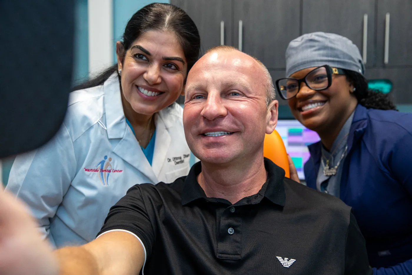 Happy patient with Dr. Dham and the Westside Dental team